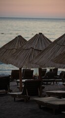 Deckchairs on the beach made of reeds, sunset on the sea
