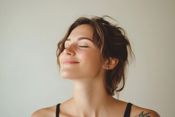 Fototapeta premium A close up of a woman's face with tattoos and her eyes closed