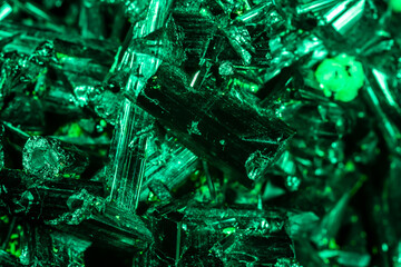 Green crystal mineral stone. Gems. Mineral crystals in the natural environment. Texture of precious and semiprecious stones. Seamless background with copy space colored shiny surface of precious stone