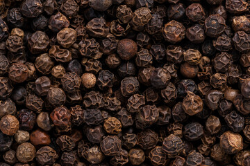 Black pepper background. Close up of black peppercorns texture.