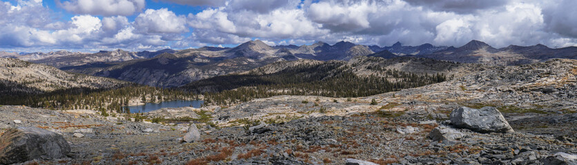 A mountain range with a lake in the foreground