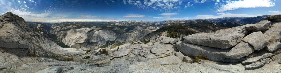 A panoramic view of a mountain range with a clear blue sky
