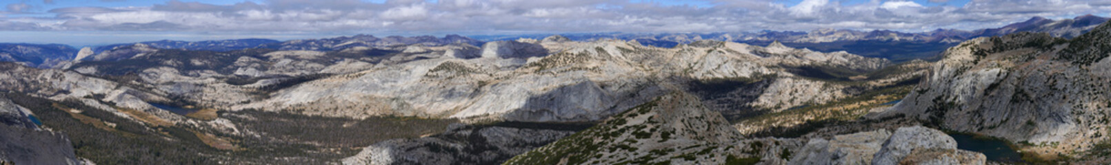 A mountain range with a cloudy sky in the background