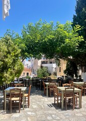Charming Outdoor Café Under Lush Greenery in a Mediterranean Village