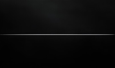 A long, thin object is shown in a black background. The object is silver and he is a wire. The image has a dark and moody atmosphere, with the black background emphasizing the object's thinness