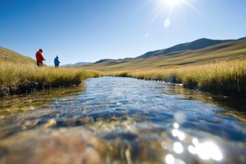 Scientists monitoring natural aquifer in remote landscape under sunny skies