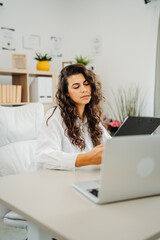 Young caucasian business woman working in office on laptop