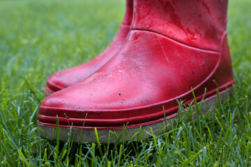 Red rain boots for protection against rainy weather.

