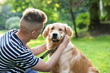 Young man with his lovely dog in park