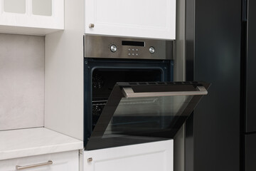 Fototapeta premium Open electric oven in kitchen. Cooking appliance