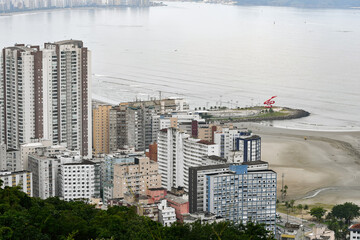 Fototapeta premium Aerial view of Santos coast, some buildings, the beach and the view to the breakwater. Santos - SP, Brazil. 