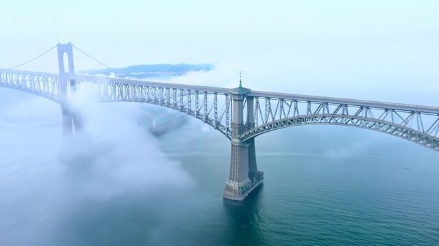 Bridge over the river in morning fog. Abstract suspension bridge on natural landscape with aerial view