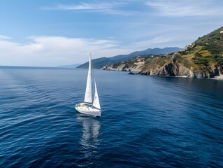 Fototapeta premium Sailing Yacht Gliding Through the Serene Mediterranean Waters Near Imperia Italy