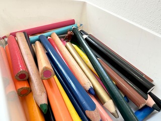 colored pencils for drawing in a box on the table, a lot of sharpened colored pencils