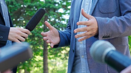 Interview with a news reporter outside in a park