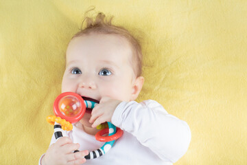 Little baby girl on colorful blanket