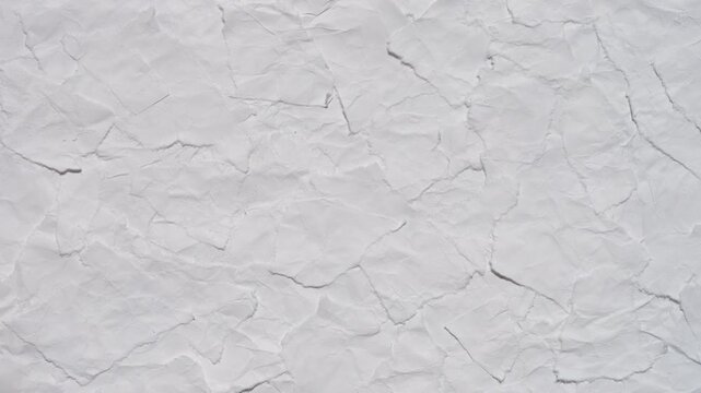 Rotating white background made of pieces of crumpled paper 