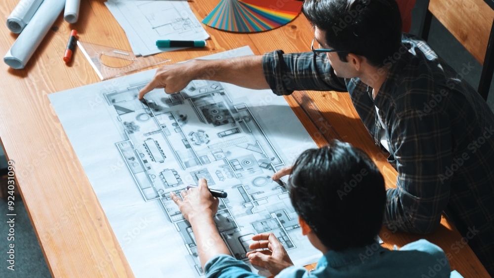 Poster group of people looking at blueprint while brainstorming idea. top view of engineer team looking and