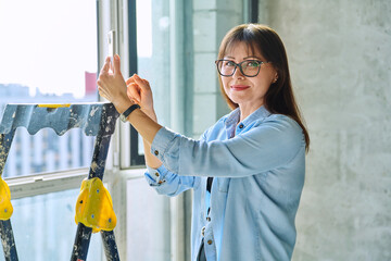 Female decorator of final finishing, repair manager in new apartment office