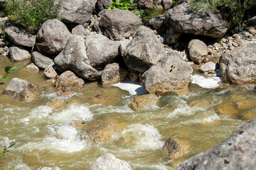 water flowing through pebbles in stream
