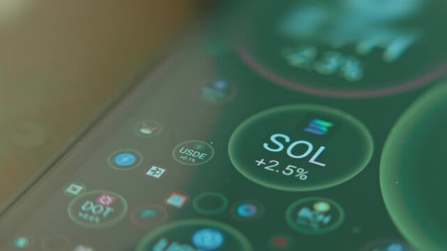 Solana SOL coin sign in a bubble among other cryptocurrencies on smartphone screen