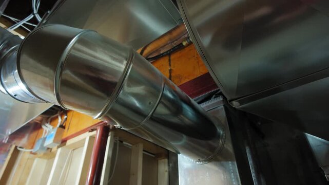Wide shot of Mounted HVAC system air conditioner return and heating system in basement. Move camera view