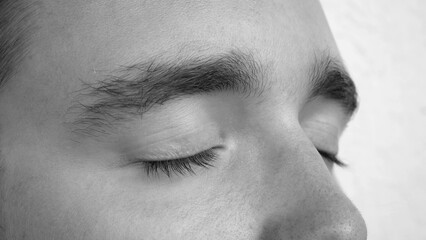 Naklejka premium Close-up of a young man's closed eyes