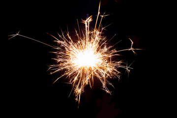 Sparklers on black isolated background. Sparks from a burning sparkler. To insert an image in a blend mode