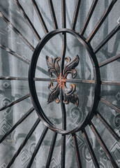old grille in the window with a decorative motif 