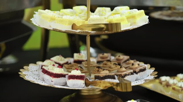 Close up shot of Candy bar, stands. Delicious desserts at the banquet, sponge cakes, shortbread tarts. move camera footage. 