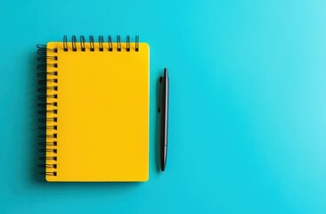 Yellow notebook with pen on blue background