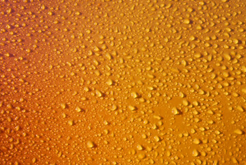 Drops on orange yellow background. Water drops on dark orange background. Shades of yellow orange colour Abstarct wet texture with bubbles. Raindrop, pure water droplets condensed for banner design