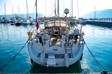 white sailboat, elegance yacht docked in marina, awaiting passengers for luxurious seaside vacation, maritime experience, ocean voyage, exclusive journey on open sea