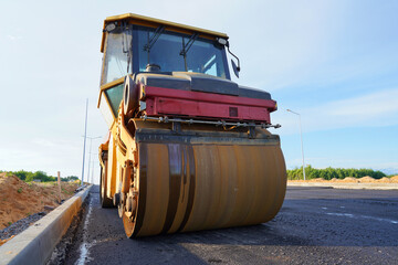 Asphalting in city road. Asphalt paving repairing. Vibrator compactor machine on roadworks. Asphalt...