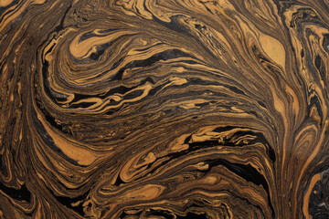 Art flow pour oil and acrylic color painting blot. Abstract liquid swirl black and gold texture background.
