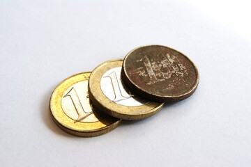 Old and new 1 euro coins on a white background. Close-up.