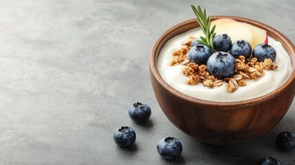 Smooth Greek yogurt topped with blueberries, apples, and granola, with a rosemary sprig, soft light, warm wooden bowl, healthy lifestyle image.