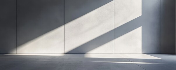 Empty modern interior with natural light casting shadows on the concrete walls and floor. Minimalistic space perfect for background or design use.