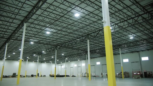 Wide shot of Inside large commercial warehouse. Move camera wide footage