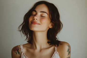 A close up of a woman's face with tattoos and her eyes closed