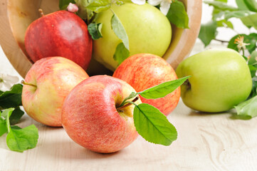 Apple with a green leaf on wooden background