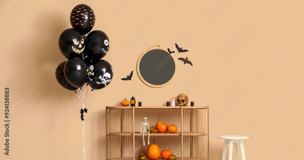 Wall mural different black halloween balloons, shelving unit, stool and mirror hanging on beige wall in room