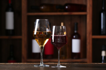 Glasses of exquisite wine on table in cellar