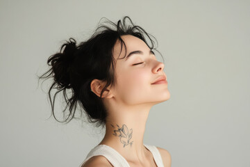 A close up of a woman's face with tattoos and her eyes closed