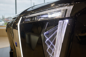 Fototapeta premium Close up of a cars headlight, part of automotive design