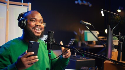 Songwriter singing new song on his microphone to produce new tracks for music industry, home studio...
