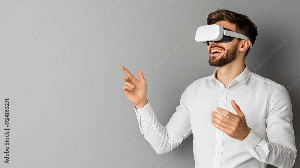 Poster a young man is smiling and gesturing joyfully while immersed in a virtual reality experience at his 