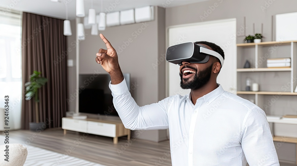 Poster a young man is smiling and gesturing joyfully while immersed in a virtual reality experience at his 
