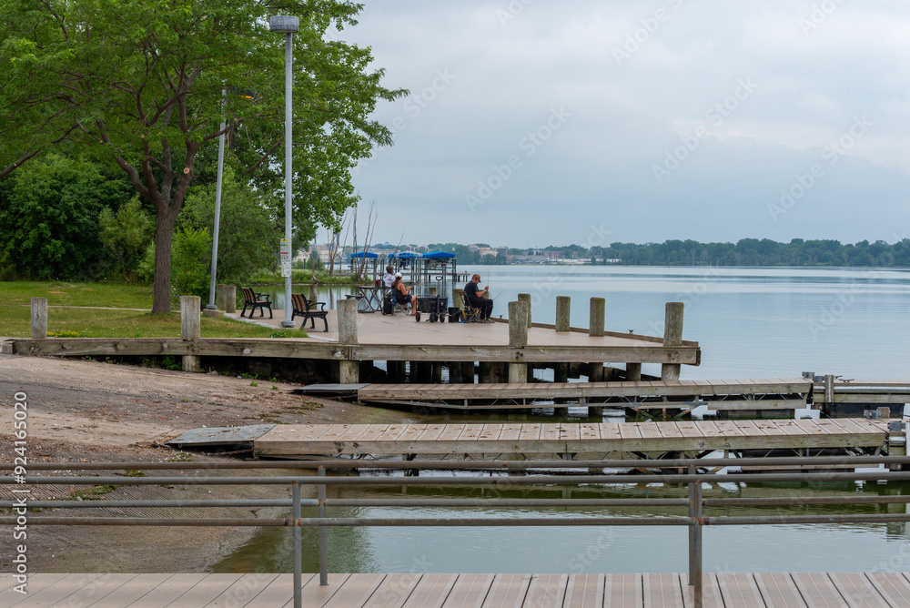 Wall mural people fishing at the dock on fox river at de pere, wisconsin, in summer