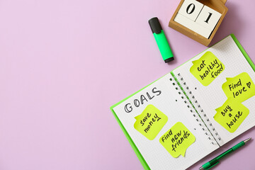 Sticky notes with to do plans, notebook and calendar on lilac background. New year goals concept